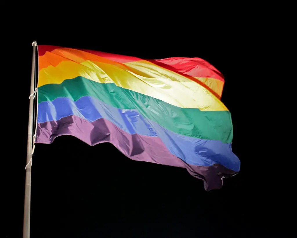 Rainbow flag against a black background.