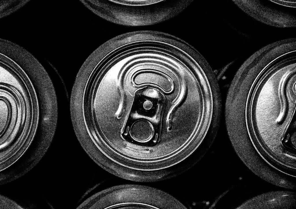 Tops of soda cans in black and white.