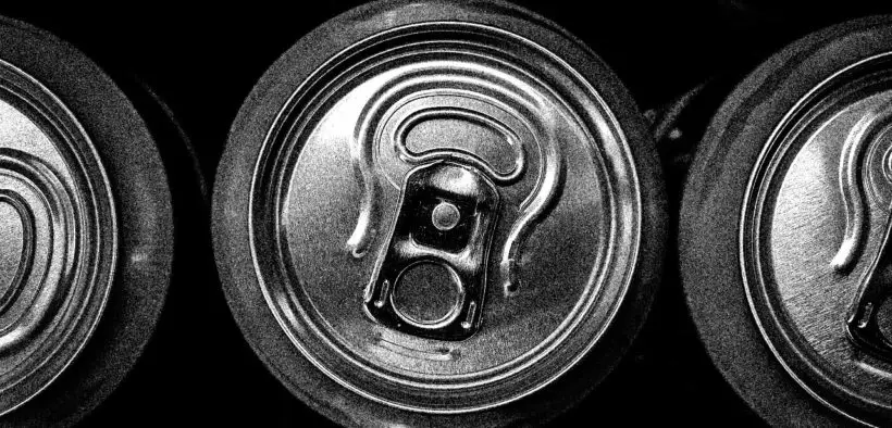 Tops of soda cans in black and white.