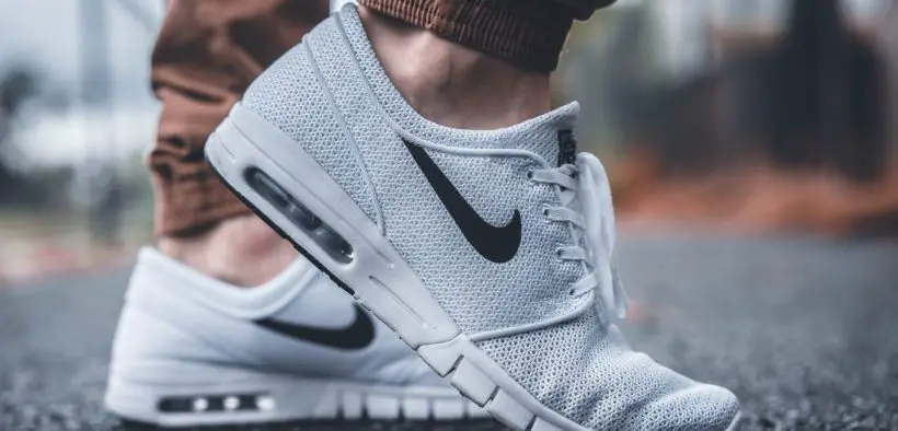 Pair of feet with Nike shoes on them.