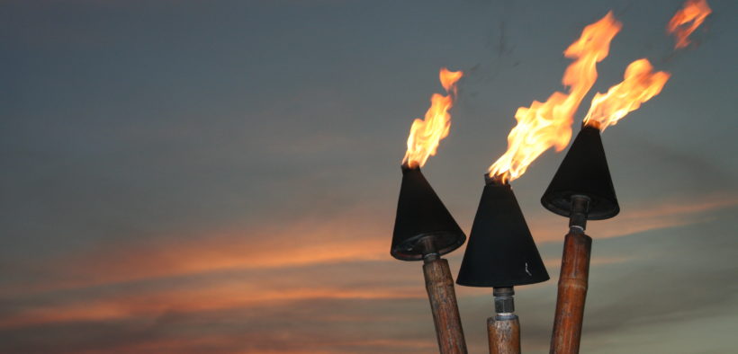 Tiki torches at sunset.