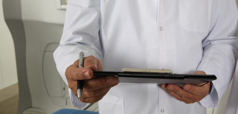 A doctor holding a clipboard.