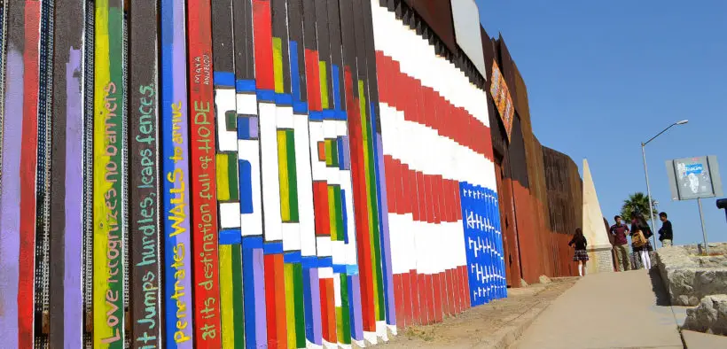 Wall separating the United States from Mexico, showing graffiti from the Tijuana side.