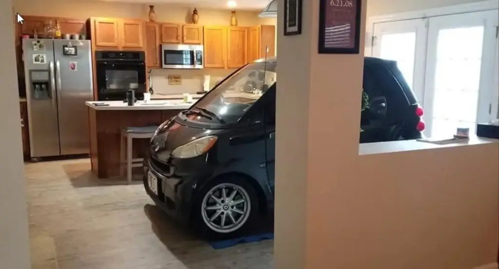 Photograph of a Smart Car inside a home.